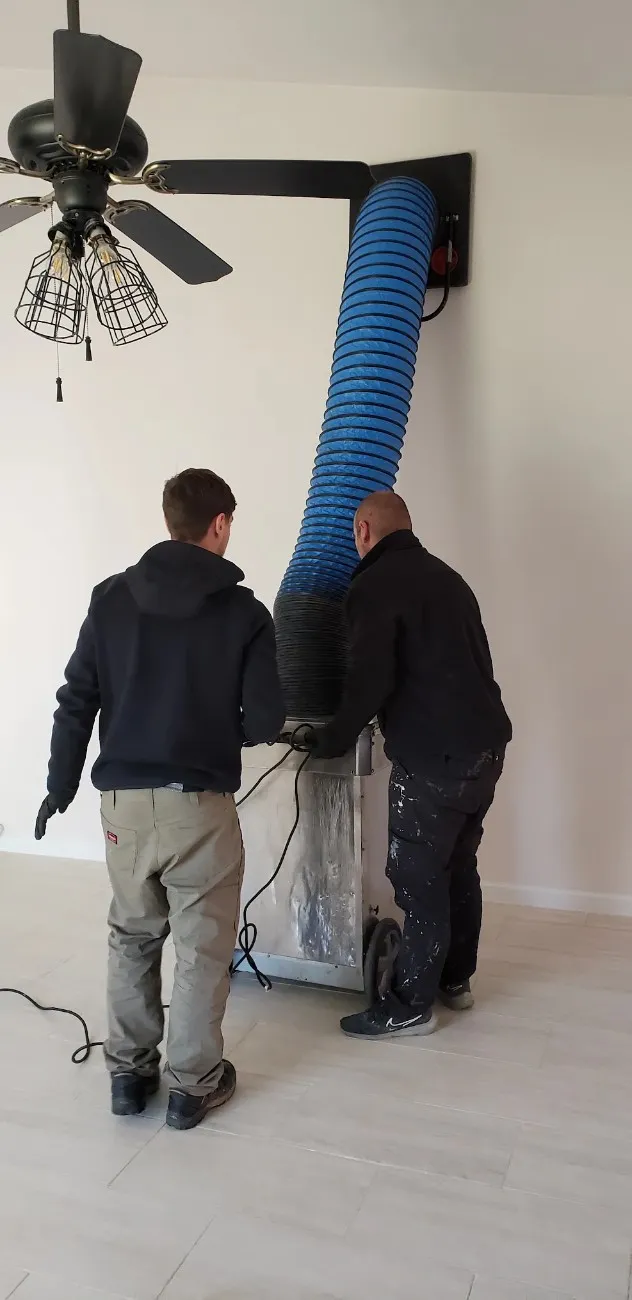 Technicians cleaning air ducts with professional equipment